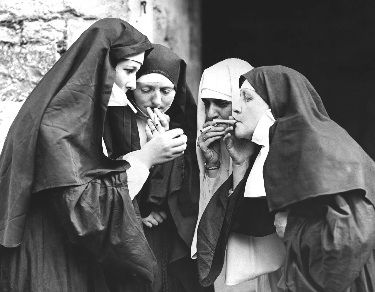 a group of nuns smoking cigarettes